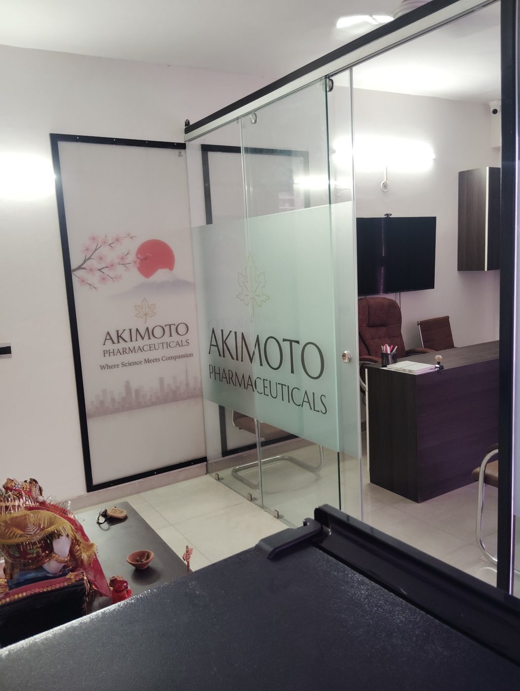 Akimoto Pharmaceuticals signage on the glass partition and wall at the Lucknow office